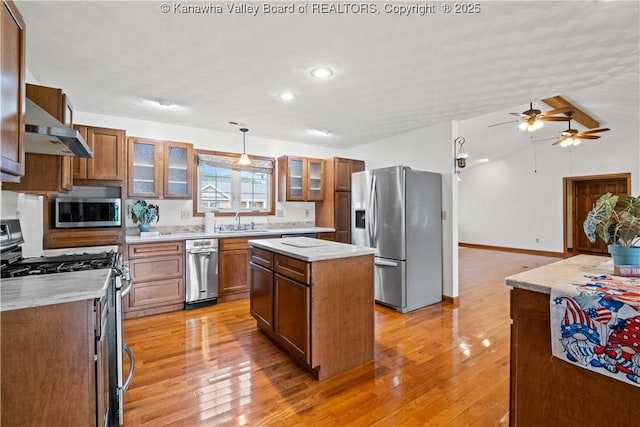 213 Rumer Sta, Red House, WV 25168 - kitchen with stainless steel appliances, wall chimney range hood, a sink, ceiling fan, and light wood-style flooring