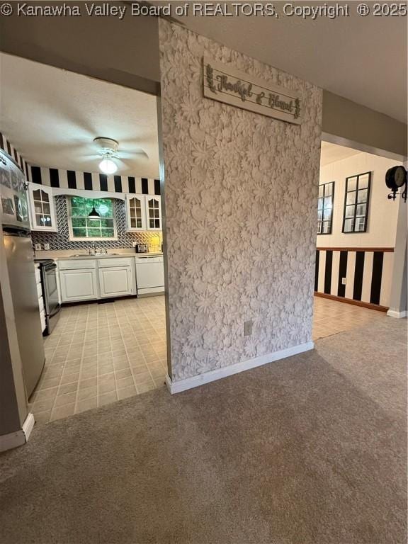 211 Geronimo Dr, Saint Albans, WV 25177 - kitchen with dishwasher, ceiling fan, electric range, white cabinets, and tasteful backsplash