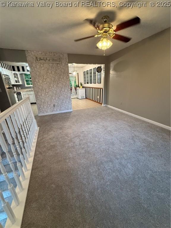 211 Geronimo Dr, Saint Albans, WV 25177 - unfurnished living room featuring ceiling fan, light colored carpet, and baseboards