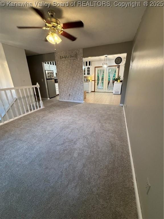 211 Geronimo Dr, Saint Albans, WV 25177 - unfurnished living room featuring carpet flooring, ceiling fan, and baseboards