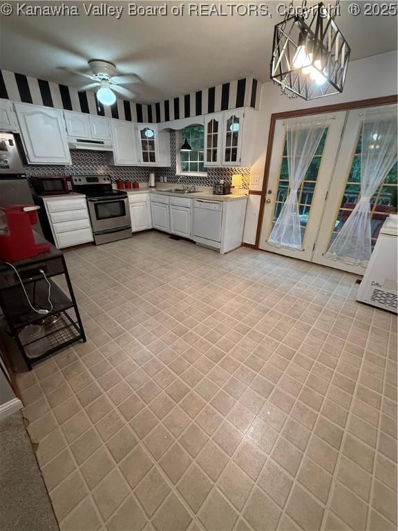 211 Geronimo Dr, Saint Albans, WV 25177 - kitchen featuring stainless steel electric range oven, under cabinet range hood, ceiling fan, white dishwasher, and backsplash