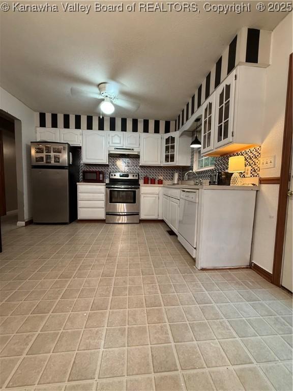 211 Geronimo Dr, Saint Albans, WV 25177 - kitchen featuring appliances with stainless steel finishes, a ceiling fan, light tile patterned flooring, under cabinet range hood, and decorative backsplash