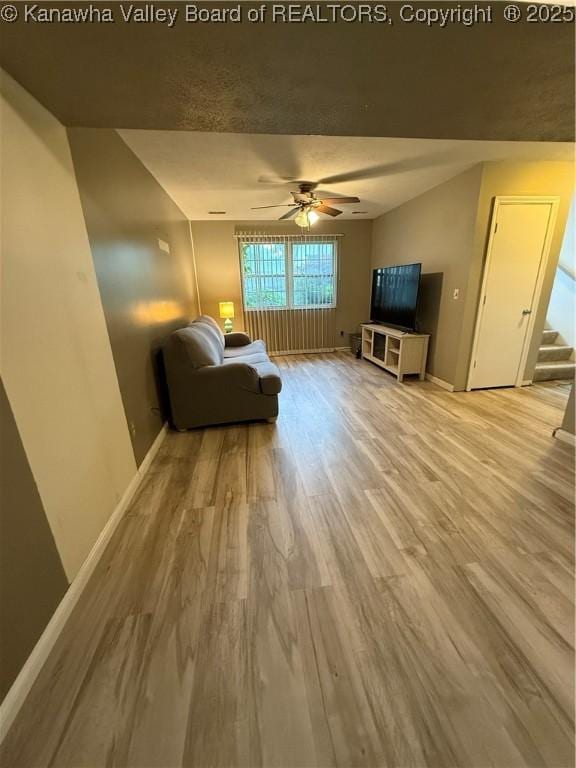 211 Geronimo Dr, Saint Albans, WV 25177 - living area with wood finished floors, baseboards, ceiling fan, and stairs