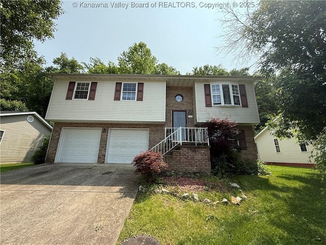 211 Geronimo Dr, Saint Albans, WV 25177 - raised ranch featuring driveway, a garage, brick siding, and a front lawn
