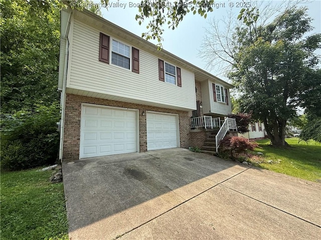 211 Geronimo Dr, Saint Albans, WV 25177 - bi-level home with an attached garage, driveway, and brick siding