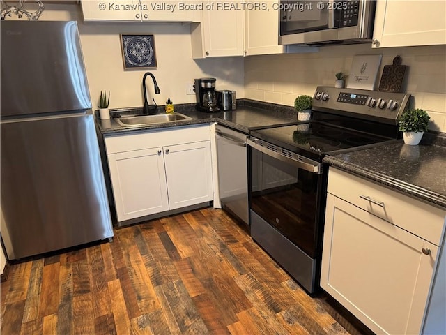 2106 Kanawha Blvd E Unit 322, Charleston, WV 25311 - kitchen featuring stainless steel appliances, a sink, white cabinets, decorative backsplash, and dark wood-style floors