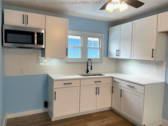 517 16th St, Dunbar, WV 25064 - kitchen with stainless steel microwave, a sink, wood finished floors, ceiling fan, and a textured ceiling
