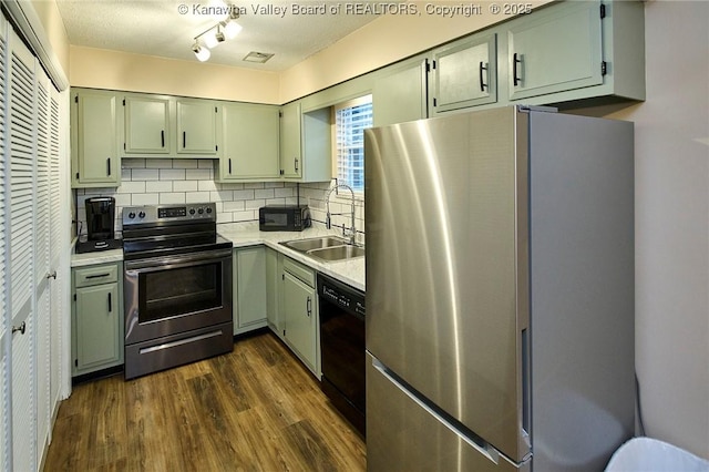 121 1st Ave, South Charleston, WV 25303 - kitchen with stainless steel appliances, a sink, dark wood finished floors, light countertops, and decorative backsplash
