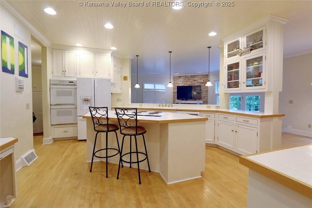 5 Stony Point Rd, Charleston, WV 25314 - kitchen with white appliances, a peninsula, light wood finished floors, white cabinets, and recessed lighting