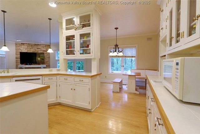 5 Stony Point Rd, Charleston, WV 25314 - kitchen featuring white appliances, light wood-style floors, pendant lighting, and ornamental molding
