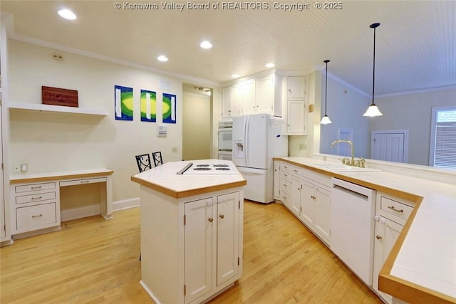 5 Stony Point Rd, Charleston, WV 25314 - kitchen with white appliances, tile counters, a sink, crown molding, and light wood-type flooring