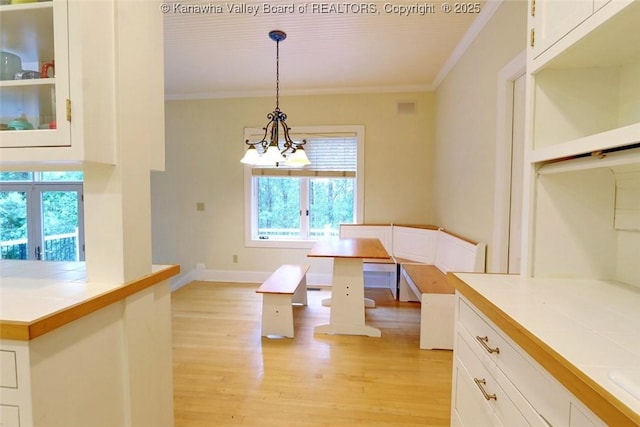 5 Stony Point Rd, Charleston, WV 25314 - unfurnished dining area with ornamental molding, a chandelier, light wood-type flooring, baseboards, and breakfast area