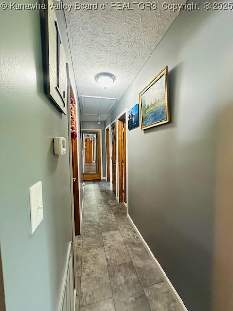 136 Timberlake Cir, Scott Depot, WV 25560 - hallway featuring attic access, baseboards, and a textured ceiling