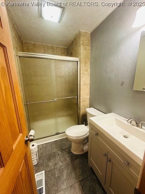 136 Timberlake Cir, Scott Depot, WV 25560 - bathroom with vanity, a textured ceiling, toilet, a shower stall, and stone finish floors