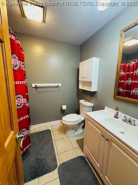 136 Timberlake Cir, Scott Depot, WV 25560 - bathroom with vanity, tile patterned flooring, toilet, a textured ceiling, and a shower with shower curtain
