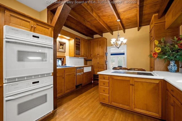 1931 Village Run Rd, White Sulphur Springs, WV 24986 - kitchen with white oven, wooden ceiling with exposed beams, black electric stovetop, brown cabinetry, and a chandelier