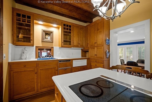 1931 Village Run Rd, White Sulphur Springs, WV 24986 - kitchen with black electric cooktop, a chandelier, light countertops, brown cabinetry, and backsplash