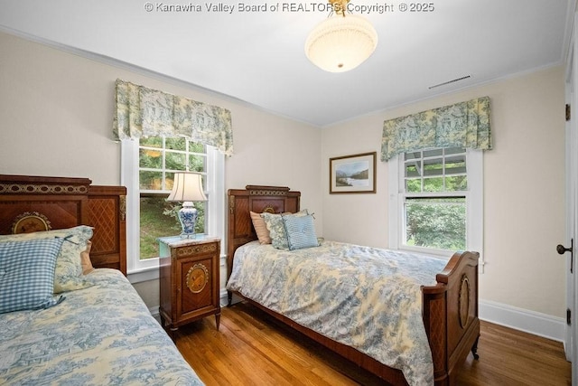 1931 Village Run Rd, White Sulphur Springs, WV 24986 - bedroom featuring ornamental molding, multiple windows, wood finished floors, and baseboards