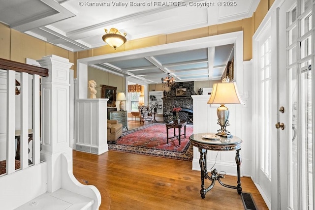 1931 Village Run Rd, White Sulphur Springs, WV 24986 - foyer entrance featuring coffered ceiling, wood finished floors, a stone fireplace, beamed ceiling, and a decorative wall