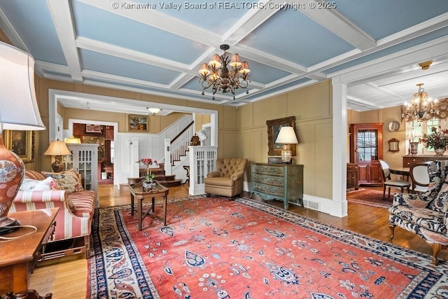 1931 Village Run Rd, White Sulphur Springs, WV 24986 - living area featuring a chandelier, wood finished floors, coffered ceiling, stairs, and a decorative wall