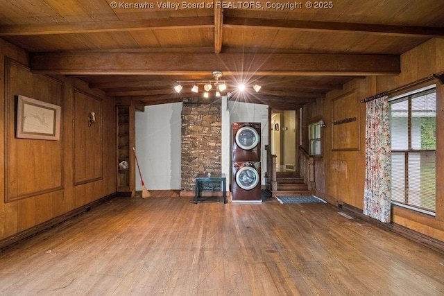 1931 Village Run Rd, White Sulphur Springs, WV 24986 - unfurnished living room featuring hardwood / wood-style flooring, estacked washer and dryer, wood ceiling with exposed beams, wooden walls, and a wood stove