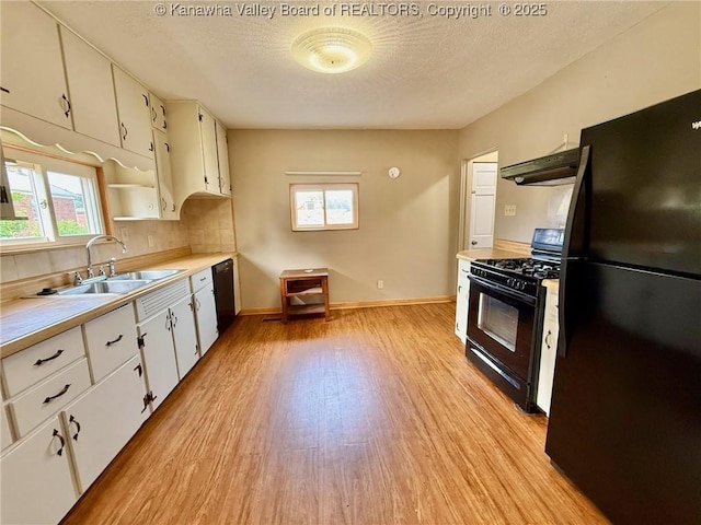 300 Sycamore St, Ravenswood, WV 26164 - kitchen featuring black appliances, a sink, light wood finished floors, under cabinet range hood, and light countertops