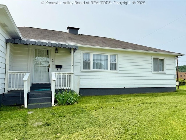 300 Sycamore St, Ravenswood, WV 26164 - back of house featuring a yard, a shingled roof, and a chimney