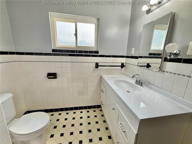 300 Sycamore St, Ravenswood, WV 26164 - half bath with tile walls, toilet, vanity, and wainscoting