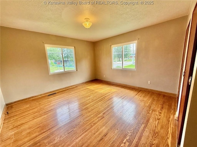 300 Sycamore St, Ravenswood, WV 26164 - unfurnished room featuring wood finished floors, a textured ceiling, and baseboards