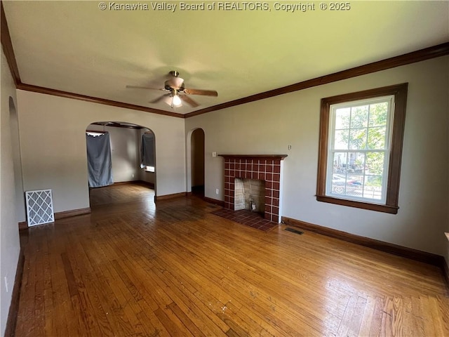 618 Hunt Ave, Charleston, WV 25302 - unfurnished living room with ceiling fan, arched walkways, hardwood / wood-style floors, a fireplace, and baseboards