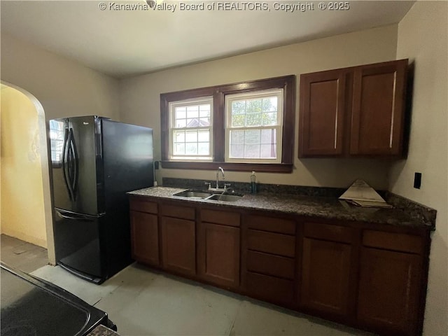 618 Hunt Ave, Charleston, WV 25302 - kitchen featuring freestanding refrigerator, a sink, dark countertops, and arched walkways
