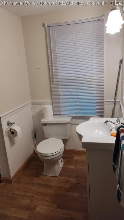 64 Haystack Ln, Charleston, WV 25311 - bathroom with toilet, wood finished floors, vanity, and wainscoting