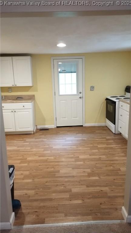 64 Haystack Ln, Charleston, WV 25311 - kitchen featuring white electric stove, white cabinetry, baseboards, light wood-style flooring, and recessed lighting