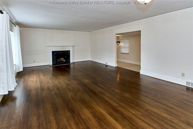 4302 Virginia Ave, Charleston, WV 25304 - unfurnished living room featuring dark wood-type flooring, a premium fireplace, and baseboards