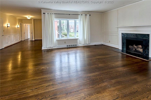 4302 Virginia Ave, Charleston, WV 25304 - unfurnished living room with ornamental molding, a fireplace, dark wood-style flooring, and a decorative wall
