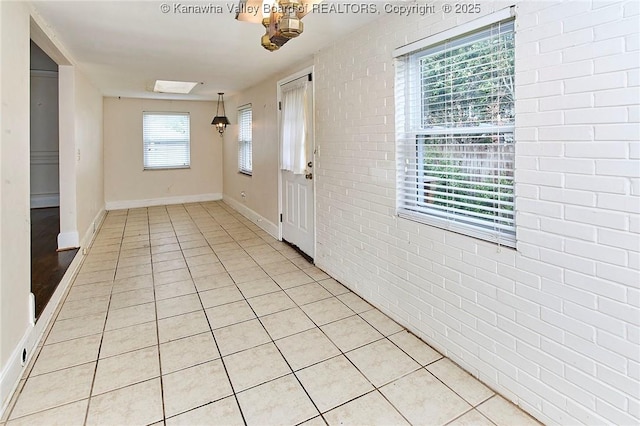 4302 Virginia Ave, Charleston, WV 25304 - foyer featuring brick wall, baseboards, and light tile patterned flooring