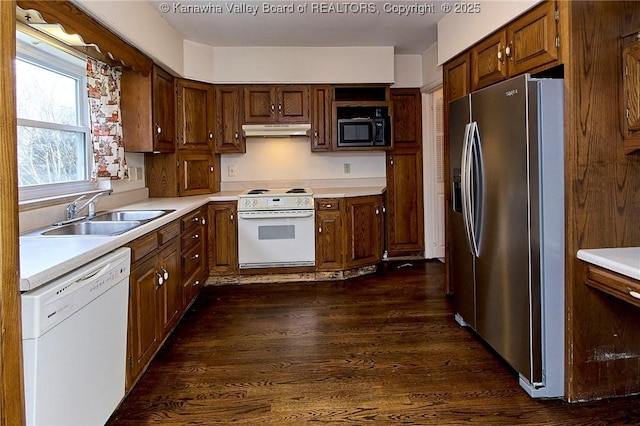 4302 Virginia Ave, Charleston, WV 25304 - kitchen featuring white appliances, under cabinet range hood, a sink, dark wood-style flooring, and light countertops