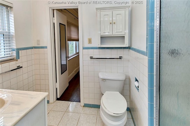 4302 Virginia Ave, Charleston, WV 25304 - bathroom with tile walls, a wainscoted wall, tile patterned floors, toilet, and vanity