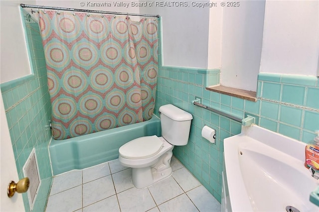 4302 Virginia Ave, Charleston, WV 25304 - full bathroom featuring tile walls, shower / bath combo with shower curtain, toilet, wainscoting, and tile patterned floors
