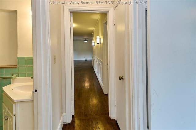 4302 Virginia Ave, Charleston, WV 25304 - hall with dark wood-type flooring, a sink, wainscoting, and tile walls