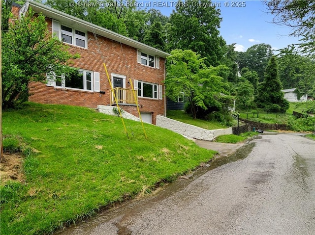 1255 Park Ave, Charleston, WV 25302 - view of front of house with brick siding, driveway, a garage, and a front lawn