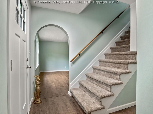 1255 Park Ave, Charleston, WV 25302 - staircase featuring wood finished floors, baseboards, and arched walkways