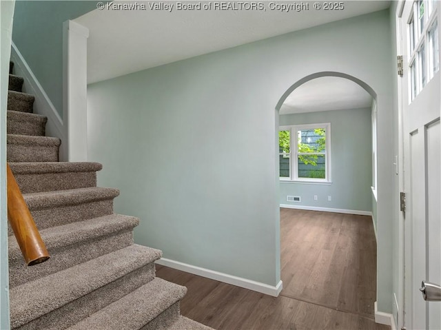 1255 Park Ave, Charleston, WV 25302 - stairs with arched walkways, baseboards, and wood finished floors