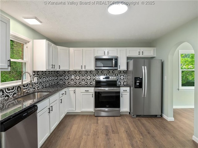 1255 Park Ave, Charleston, WV 25302 - kitchen featuring appliances with stainless steel finishes, a sink, wood finished floors, and tasteful backsplash