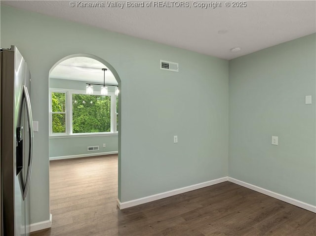 1255 Park Ave, Charleston, WV 25302 - empty room featuring arched walkways, dark wood-style floors, and baseboards