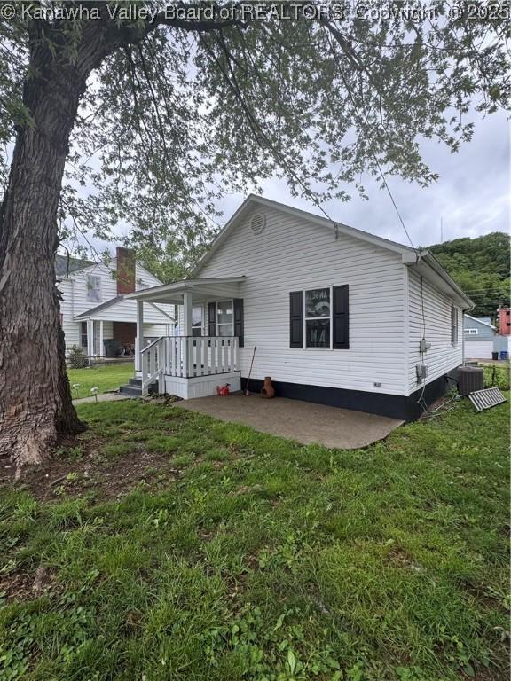 3120 5th Ave, Charleston, WV 25312 - rear view of house with a lawn, covered porch, and central air condition unit