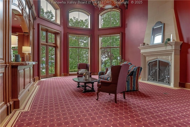 230 Quarry Rdg E, Charleston, WV 25304 - living area with carpet flooring, a fireplace, healthy amount of natural light, a towering ceiling, and a chandelier