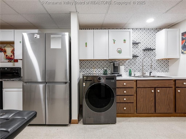 123 Brooke St, Culloden, WV 25510 - kitchen featuring freestanding refrigerator, washer / clothes dryer, a sink, light floors, and white cabinetry