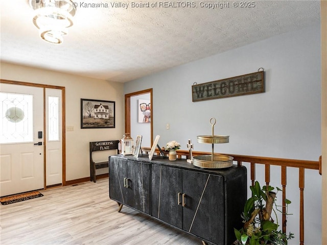 123 Brooke St, Culloden, WV 25510 - entryway featuring light wood-style floors, a chandelier, and a textured ceiling