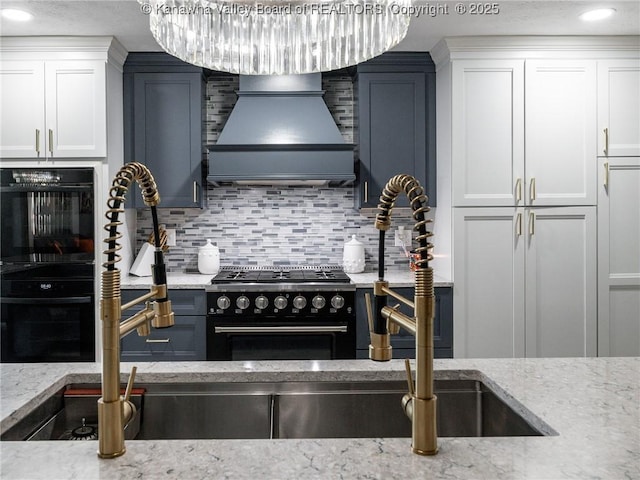123 Brooke St, Culloden, WV 25510 - kitchen featuring gas range oven, island range hood, tasteful backsplash, white cabinetry, and light stone countertops